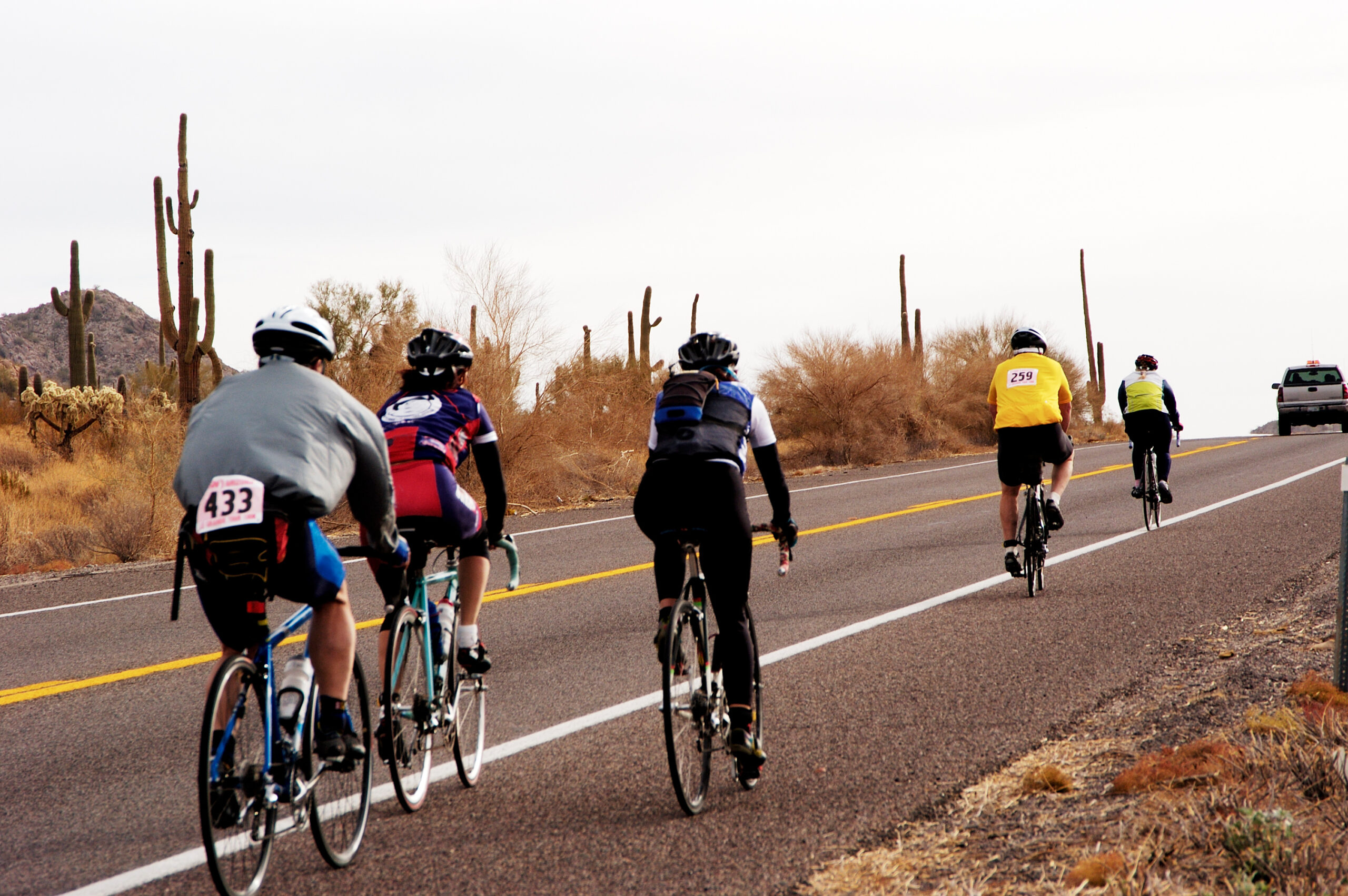 Cyclists riding through the desert of AZ